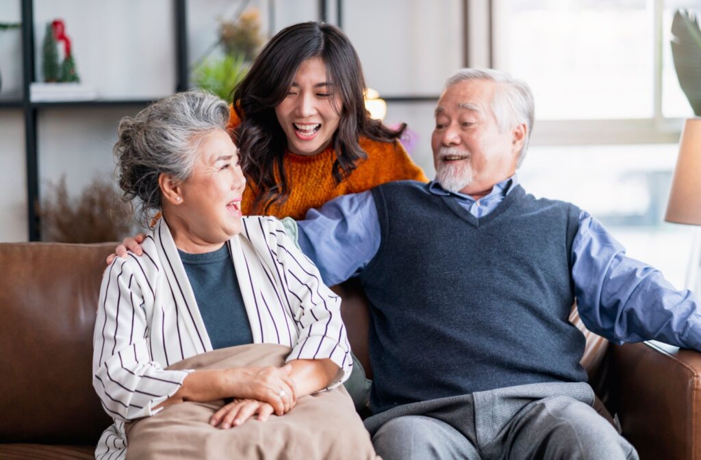 Daughter  laughing with her senior parents.