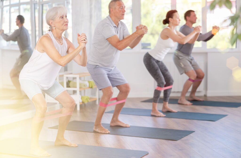 A group of seniors follow an instructor in an exercise class.