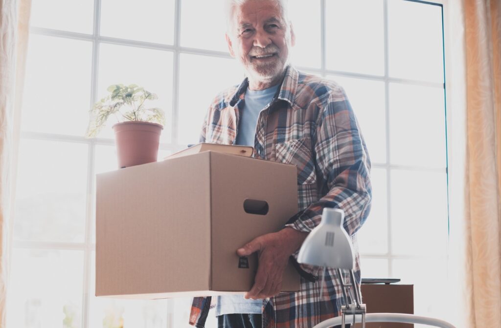 a senior carrying a box while moving