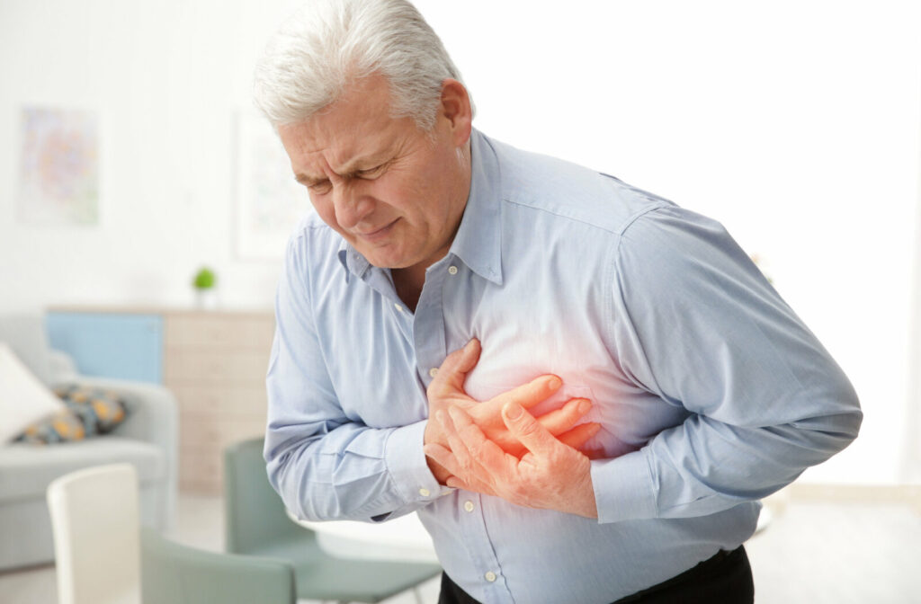 A senior man pressing his chest with both hands suffering from chest pain.