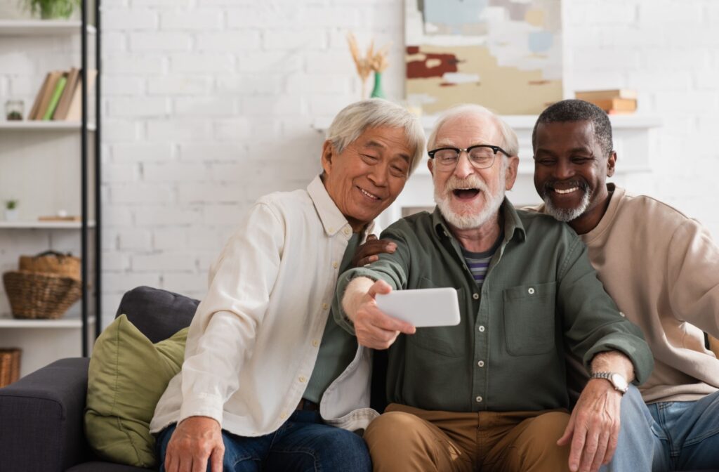 Three senior men taking a selfie and laughing.