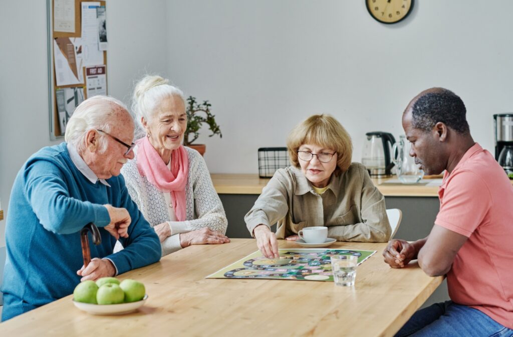 A group of seniors play a board game together.